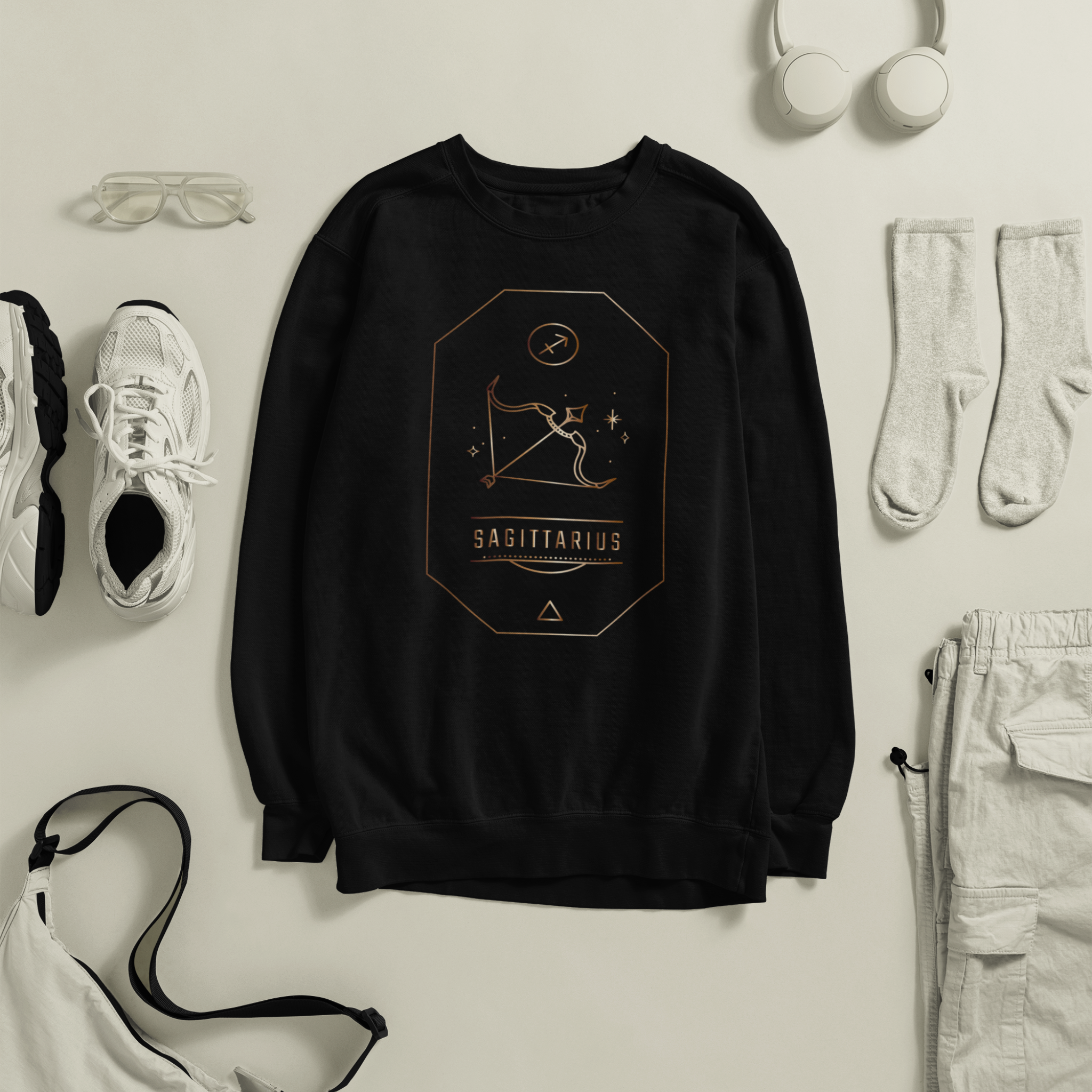 Black sweatshirt with 'Sagittarius' design surrounded by casual clothing items on a light background
